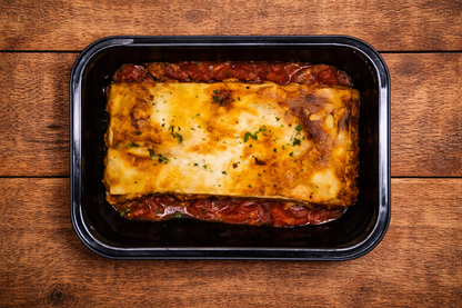 Frozen beef lasagna meal in tray, layered with beef mince, tomato sauce, and melted cheese