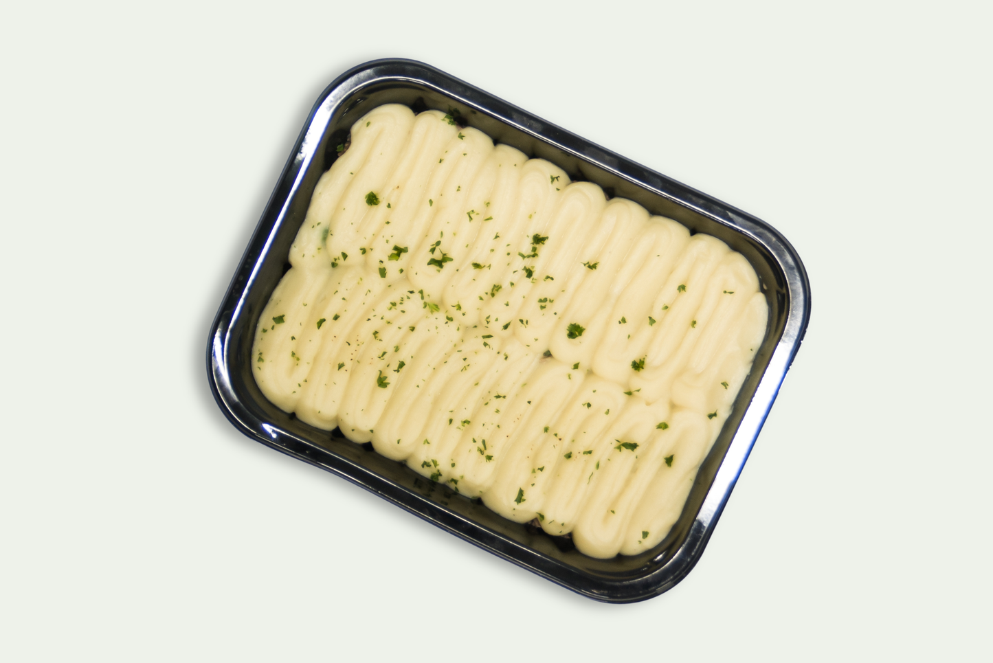 Frozen cottage pie with beef mince, vegetables, and mashed potato topping in tray